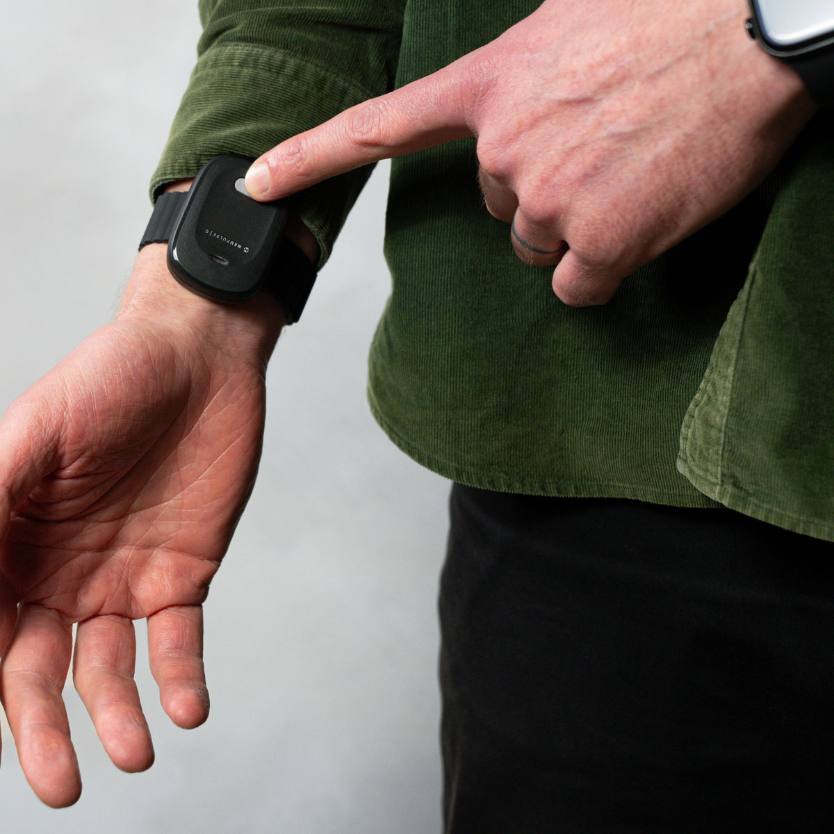Man demonstrating how to switch on the Neupulse C wearable
