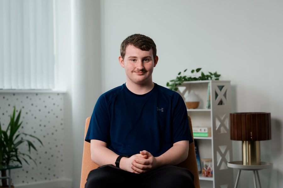 Ollie, a member of the Neupulse community, sitting in a chair