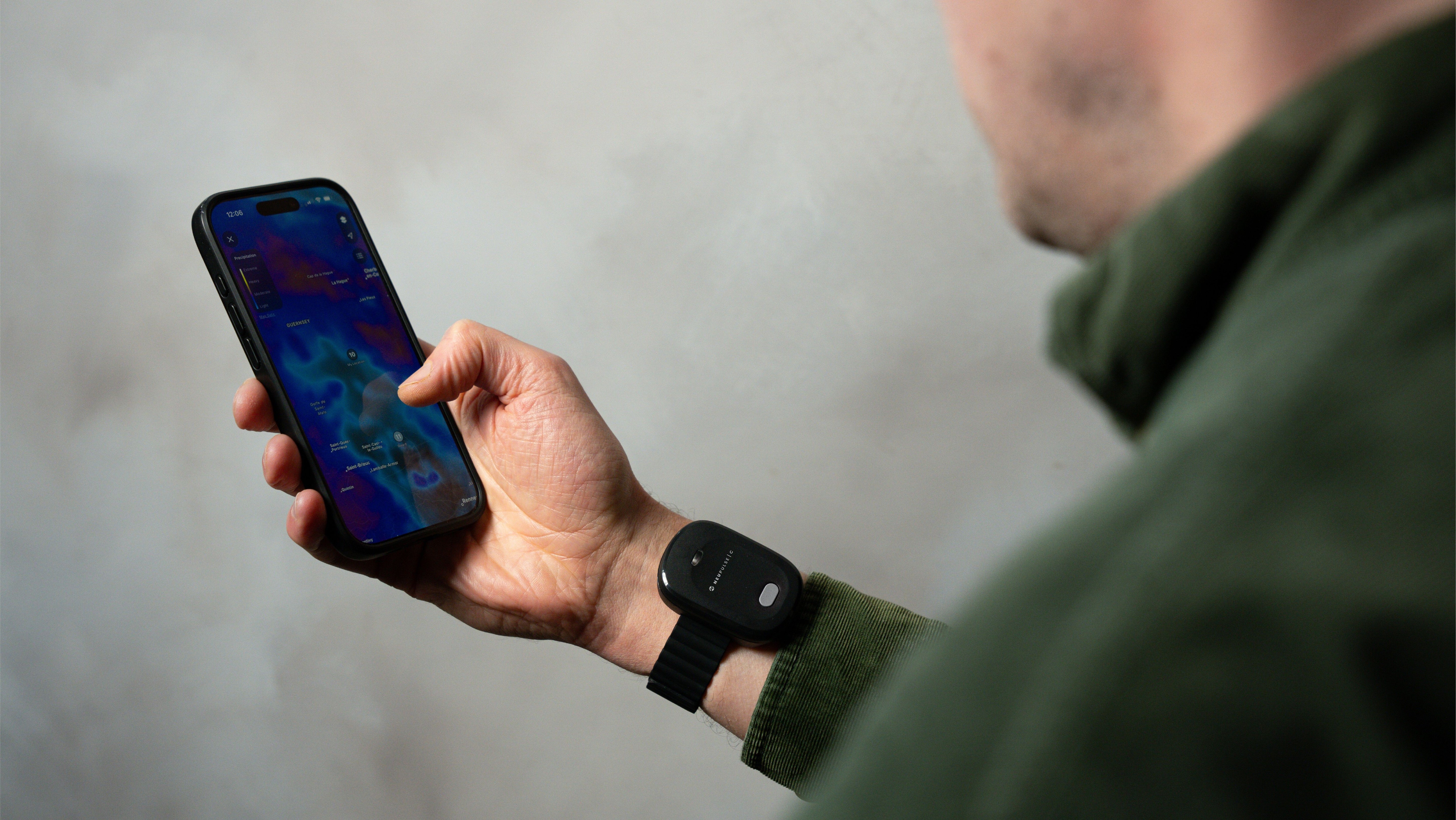 Person using their phone whilst wearing a stress relief device 